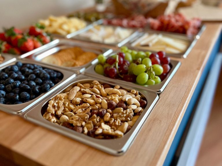 A selection of charcuterie foods inside the Le Petit Chariot luxury grazing cart A selection of fruits, nuts, cheeses, and charcuterie meats arranged on the Le Petit Chariot luxury grazing cart, ready for a wedding.