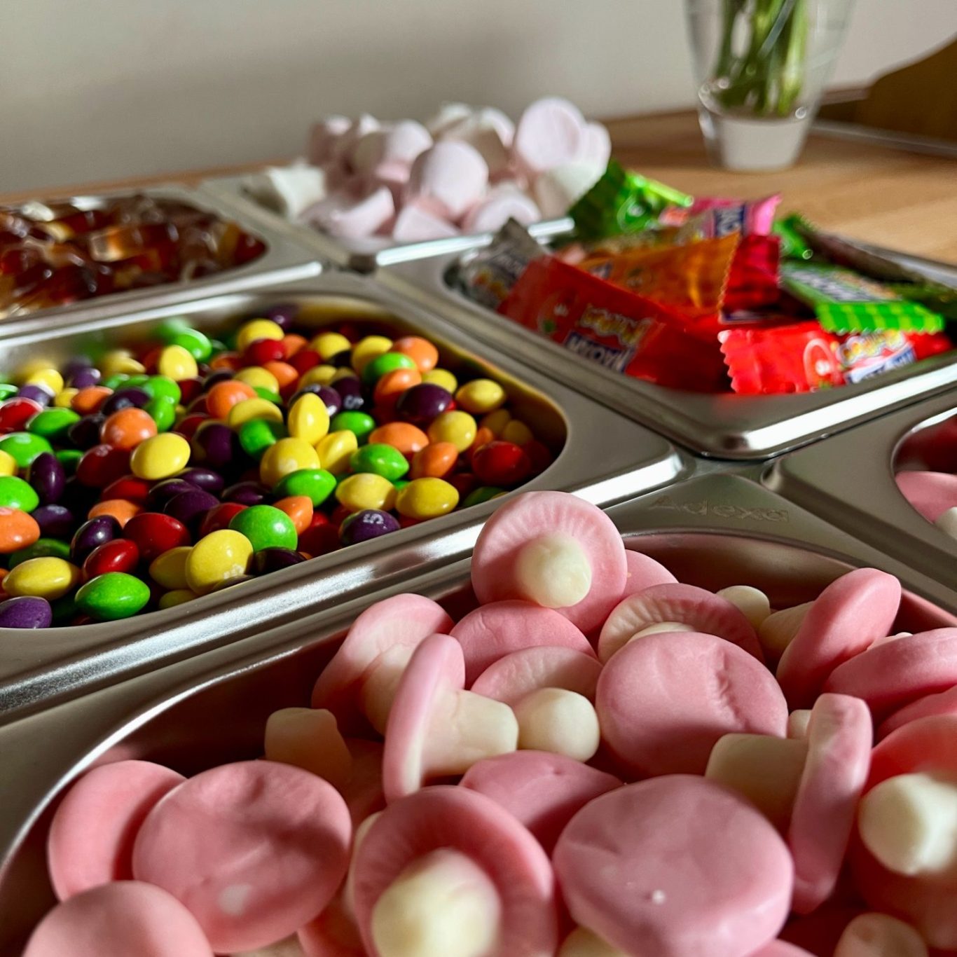 A selection of pick and mix sweets arranged on the Le Petit Chariot luxury grazing cart, ready for a wedding in The Lake District.
